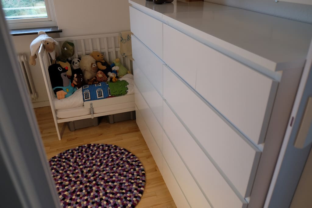 Toddler bed placed next to master bed.