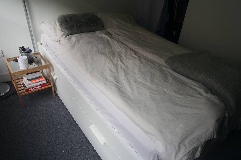 The bed with the nightstand.