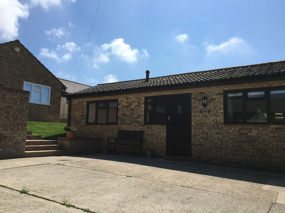 Owner's house to the left of the annexe providing beach access