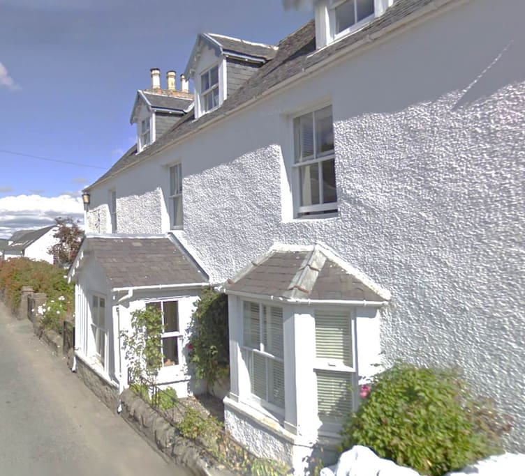 The view you see as you come down the hill towards the sea. This is the Manse on the RHS.