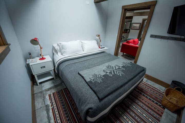 Queen Bedded Room with high quality linens and wool blankets.