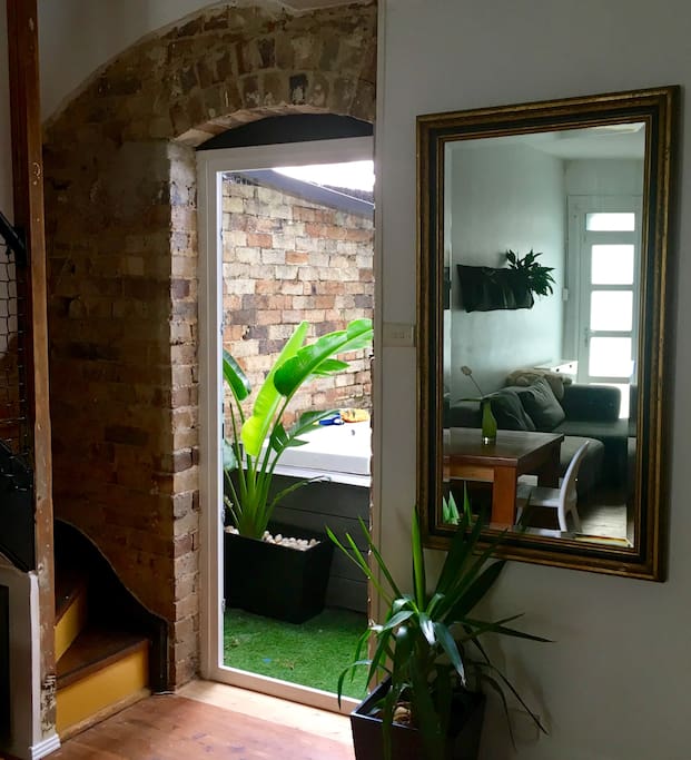 Door to outdoor bath (and living room, in mirror)