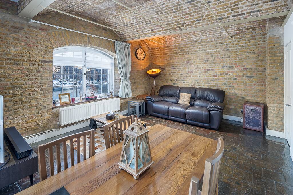 Spacious light living area with dining table
