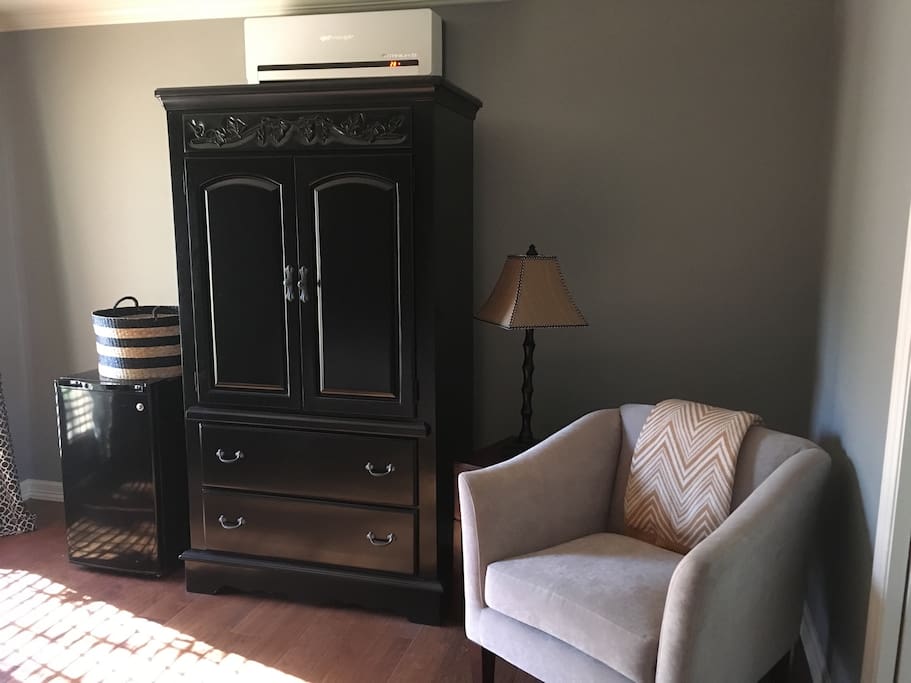 TV with local channels, small reading area, and fridge