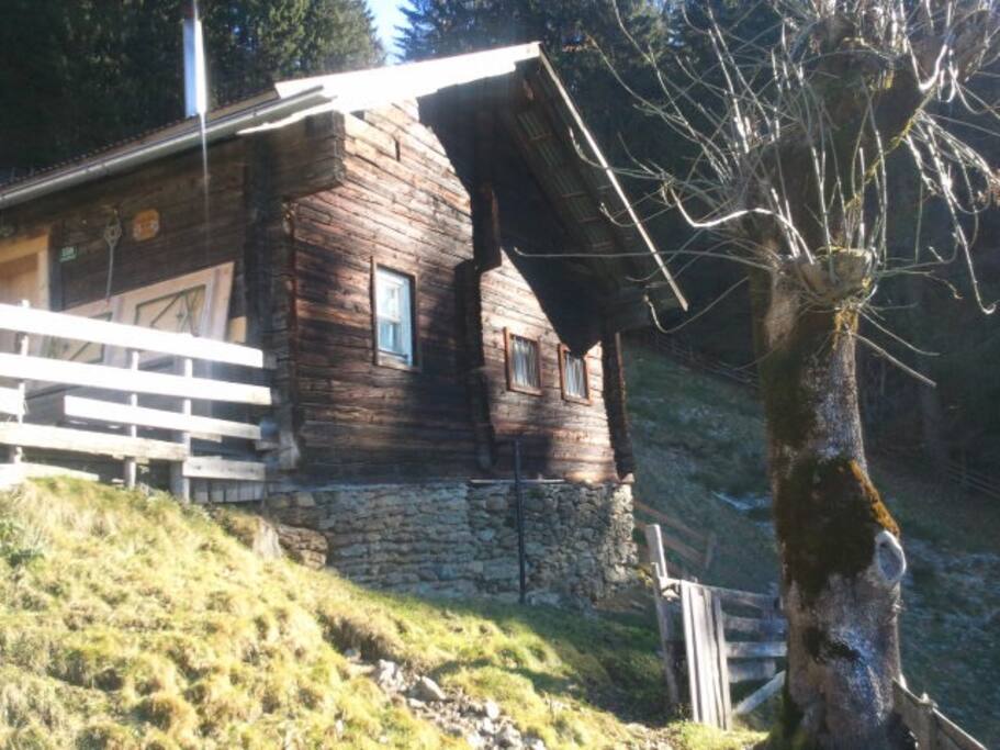 Die kleine Hütte im Spätherbstlicht am steilen Hang