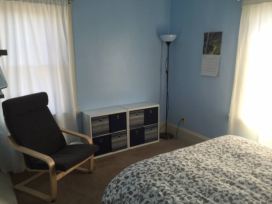 Seating area within the room with a ceiling fan, low lighting and an overhead light.