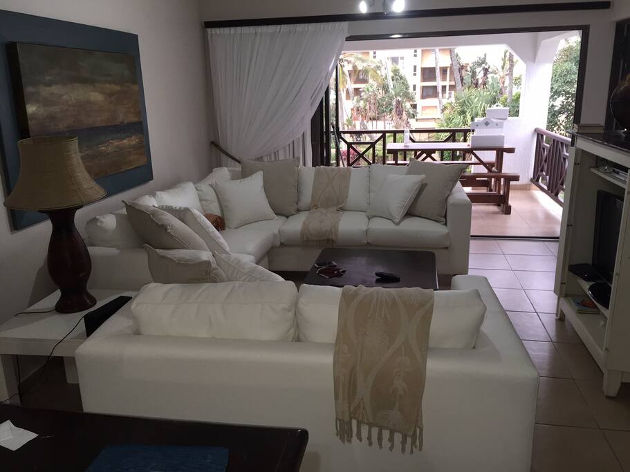 Open plan lounge, dining room, kitchen with stacker doors to patio, sea view.