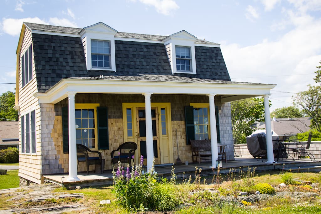 The backside of the cottage with a wonderful covered porch where you can sit and look at the open ocean.