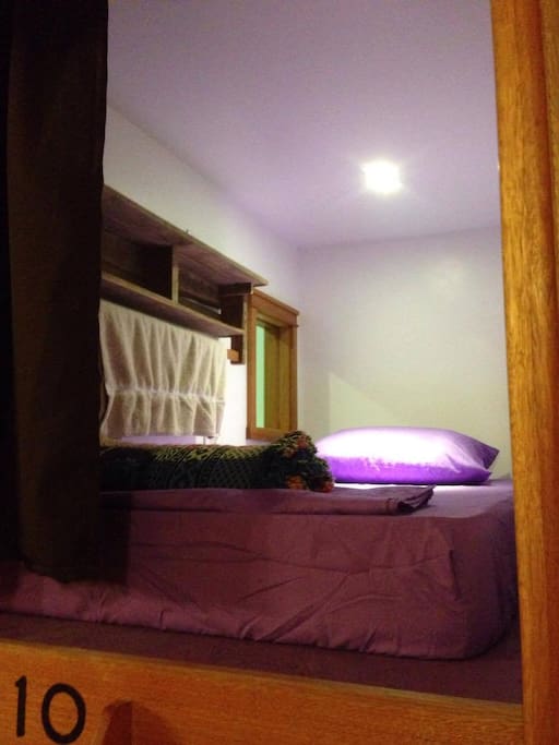 in a "Pod". You can pull the curtain, open or close the small door that connects to the pod next to you, turn the light or fan on and off, and plug in you device.