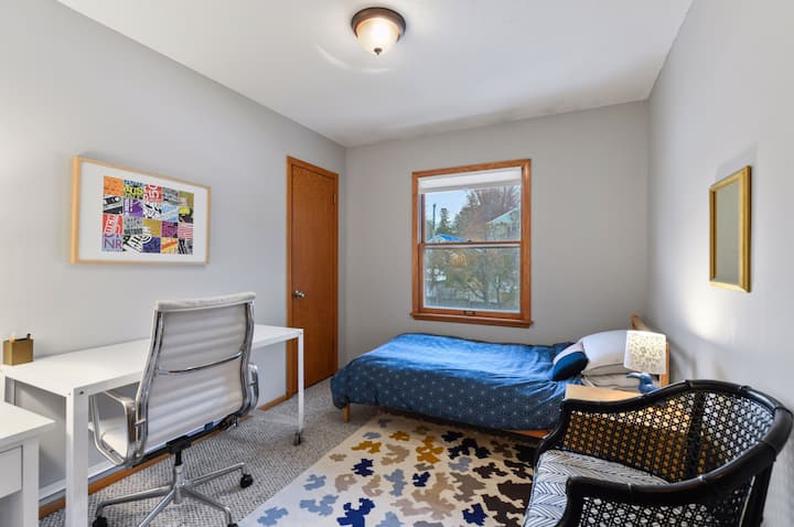 Twin bed with office space and darkening shade