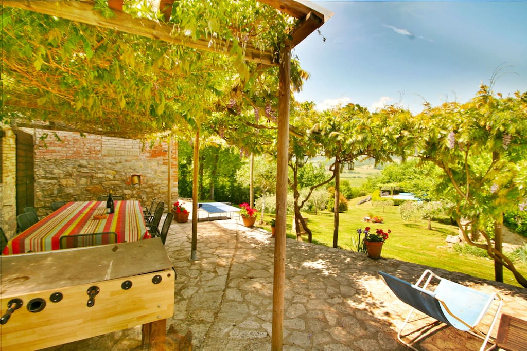 The large shady terrace with large dining table, BBQ, table tennis, etc.