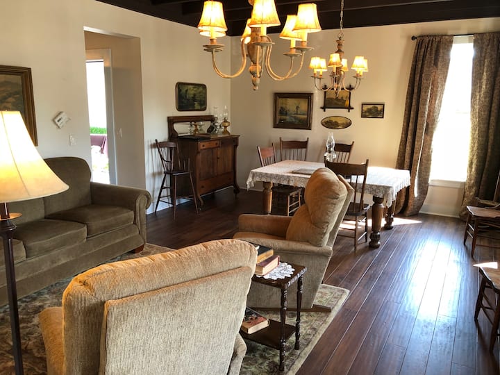 Family room with couch, two recliners and dining table.