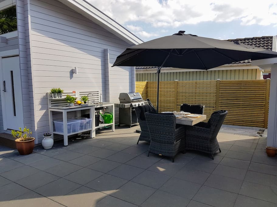 Outdoor kitchen, gas grill and garden dining area