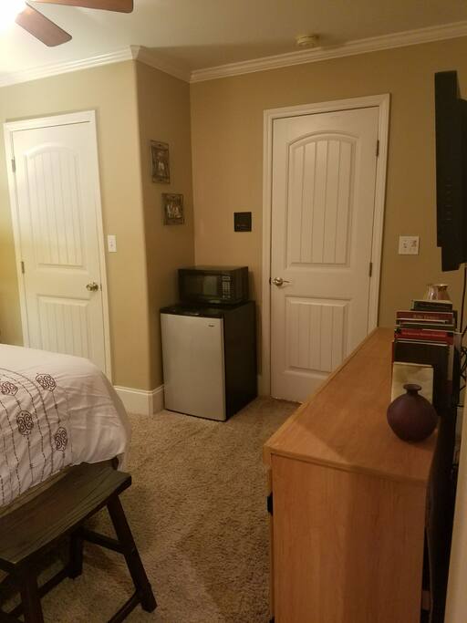 The suite is equipped with refrigerator, microwave, and an iron with ironing board in the closet.