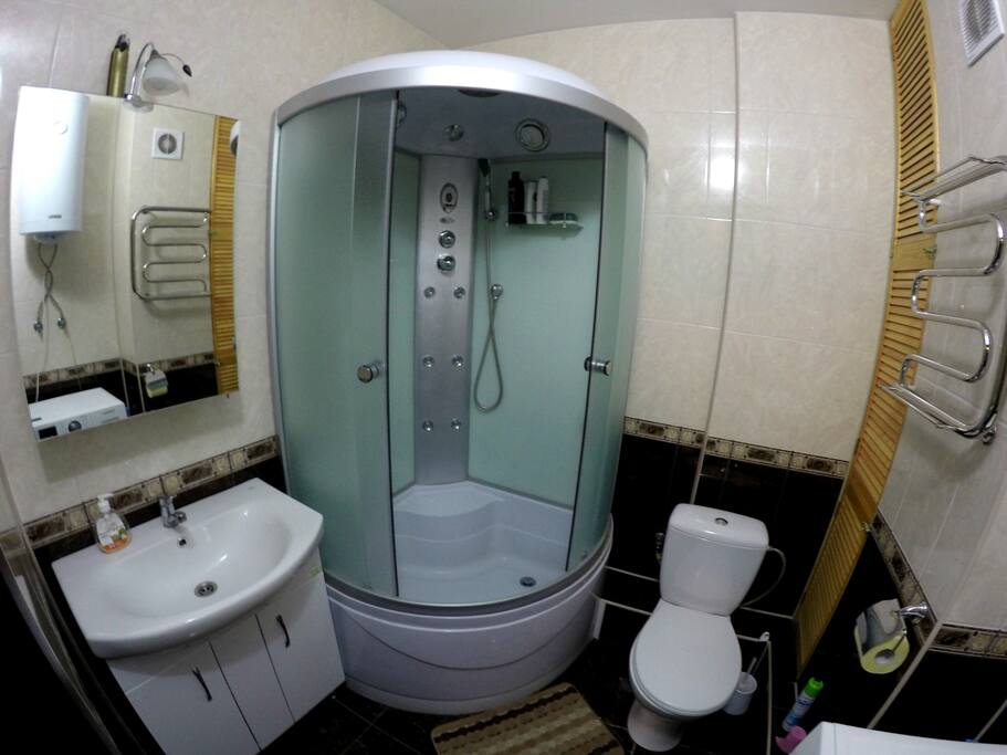 A cozy bathroom with separate cabin and shower multifunctional