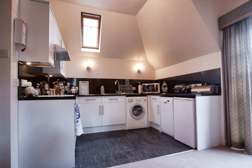 Full kitchen open plan to living/dining area. Kitchen has oven, hob, compact dishwasher, washer/dryer, small fridge/freezer, toaster, coffee maker etc.