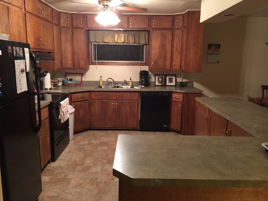 Lots of counter space to use - the breakfast bar is to the right with electrical outlets and room for your laptop and files.