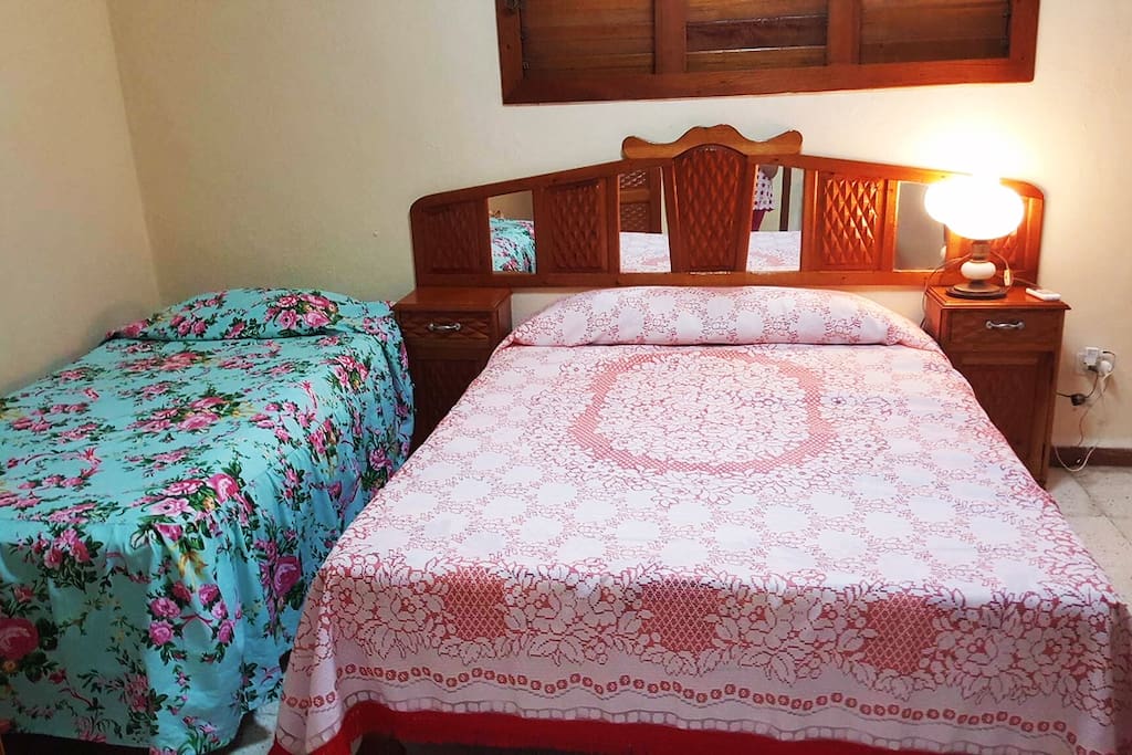 Comfortable bedroom with AC, storage space and private bathroom.