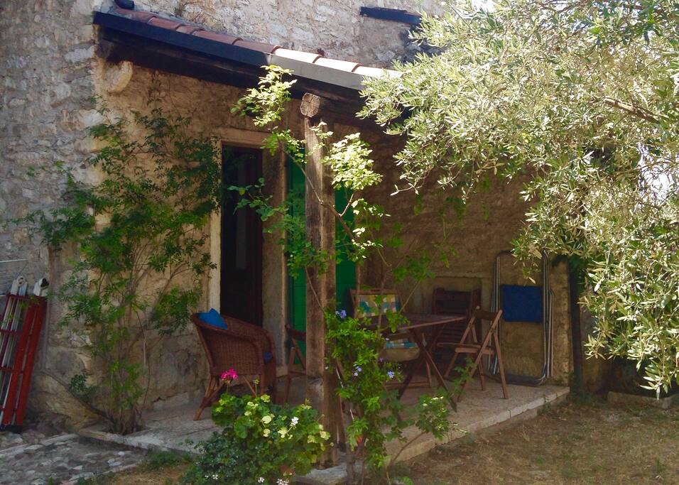 The shady covered seating area on the courtyard side of the house.