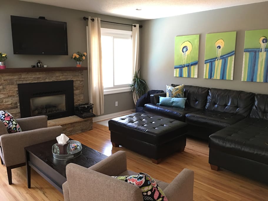 Open living room space with gas fireplace and Apple TV.