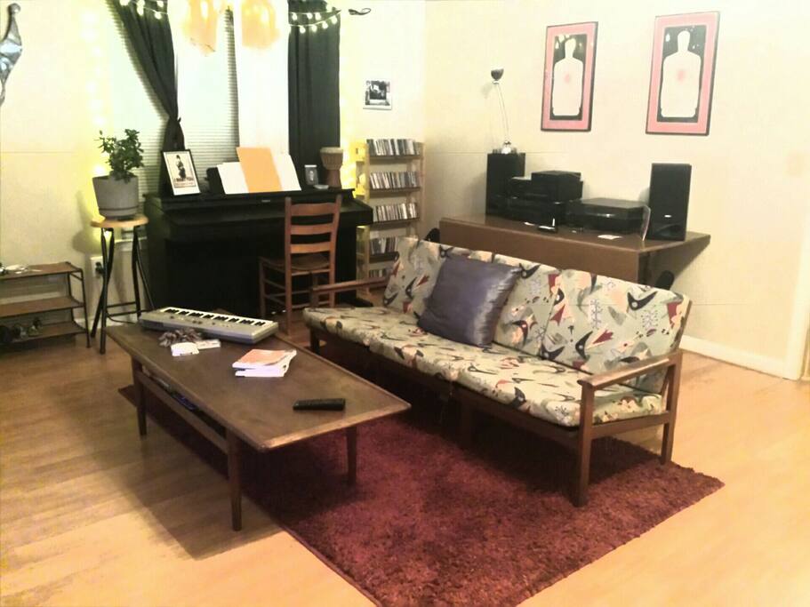 Living room. Piano, Stereo, TV/DVD player and some odd instruments.