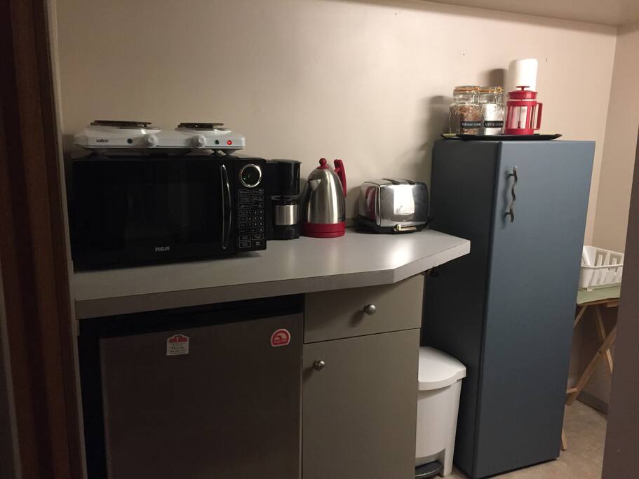 Kitchenette with bar fridge, microwave, hotplate, coffee maker, kettle, toaster, pots & dishes