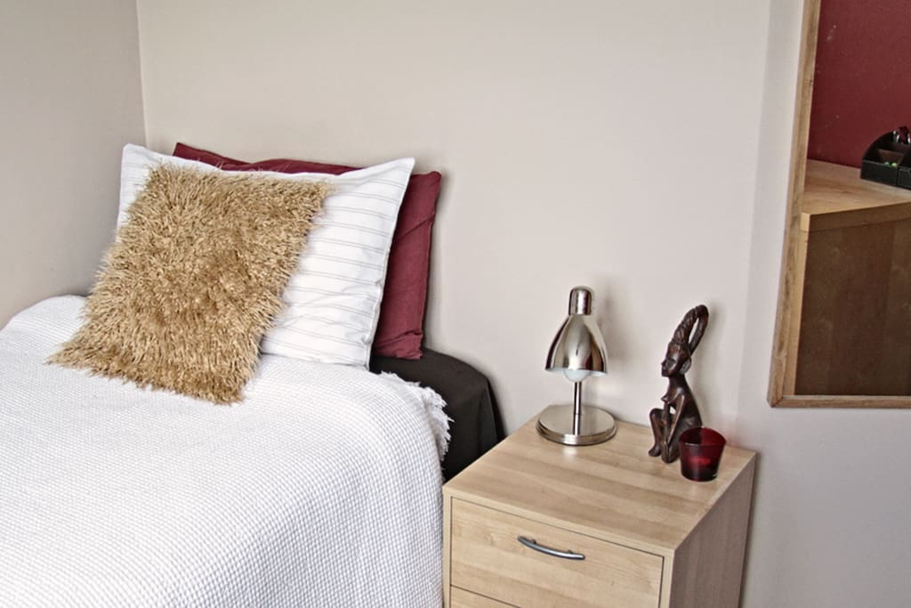 Your room: bed and bedside table