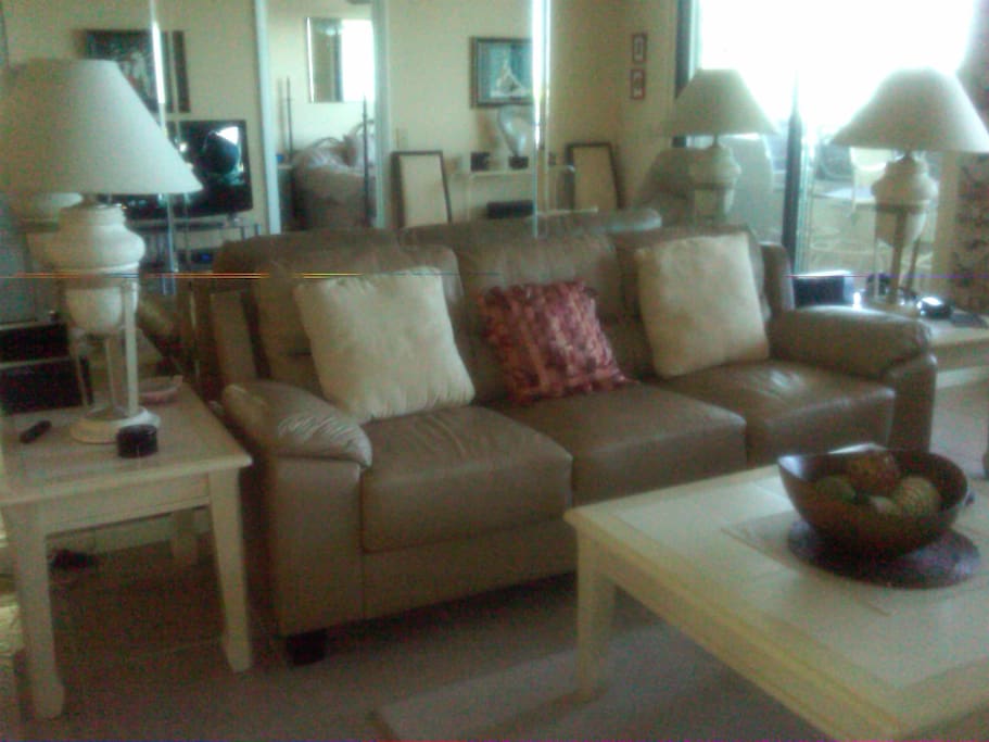 Mirrored living room with sliding glass door to balcony