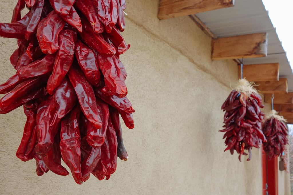 New Mexican Red Chile Ristras welcome you to the Red Door Casita.
