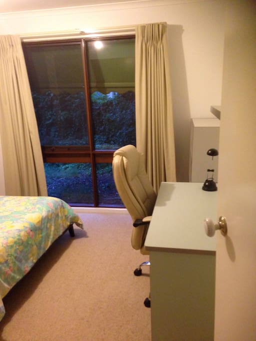 Lots of light through large window and desk and reading lamp for study