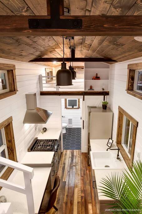 Spacious kitchen area with fridge, deep sink, dishwasher and gas stove