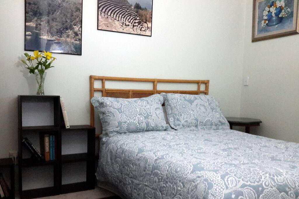 Freshly painted room with new carpets, bedside tables, reading lamp (not shown).
