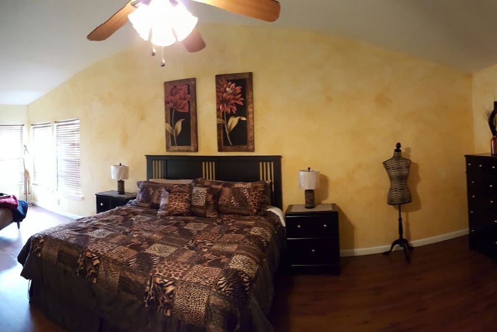 Master bedroom with king bed and sitting area.