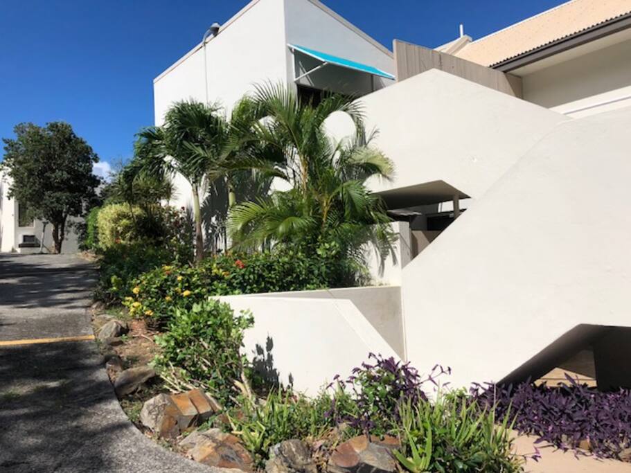 Your AirBnB condo is up the stairs. Private entry is under the blue awning. Private parking is at the bottom of the stairs.