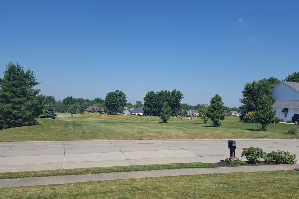 Front view of Golf course. You could walk right across the street and be at the clubhouse. Play some rounds of golf.
