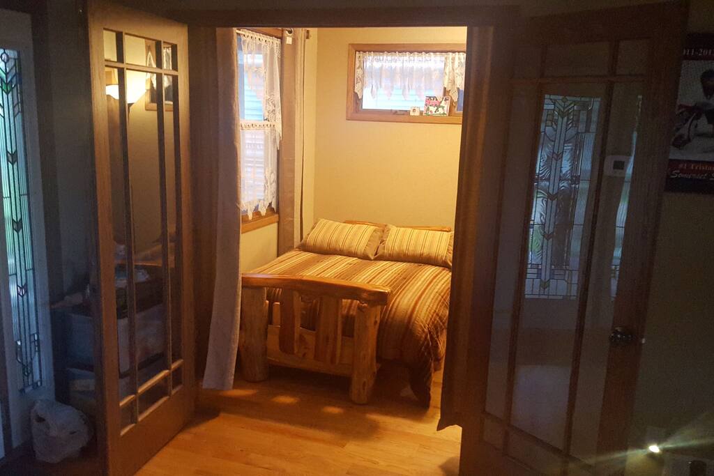 main floor sleeping room with blinds to cover windows & glass French doors for privacy