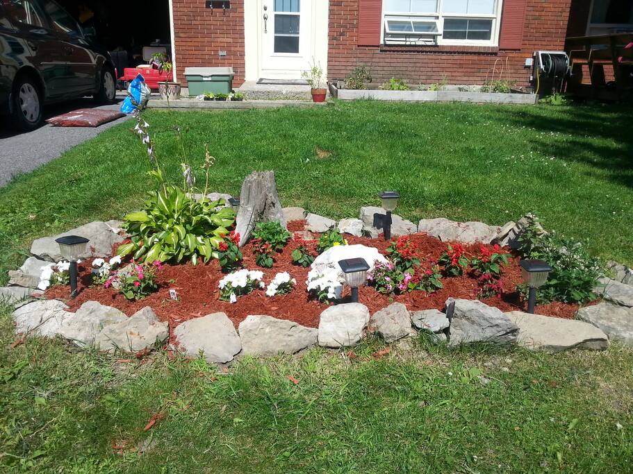 Front yard with garden and large, mature trees