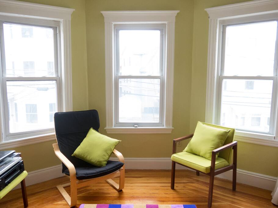Sunny living room with bay windows.