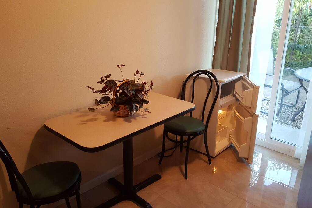 Dinning / work table, freezer/refrigerator in room