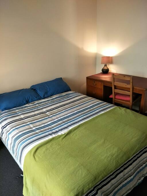 Double bed with desk and a fan for those hot nights.