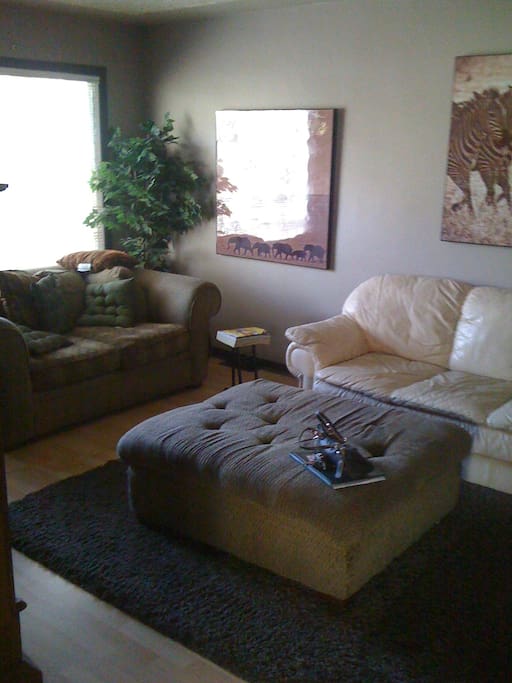 Living Room with Leather couch and soft sofa w/ ottoman