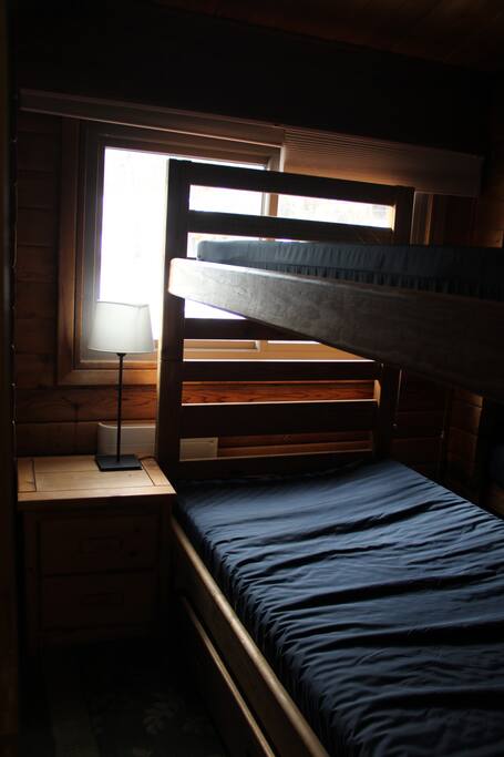 Twin bunk beds all throughout the space. Wooden and rustic.