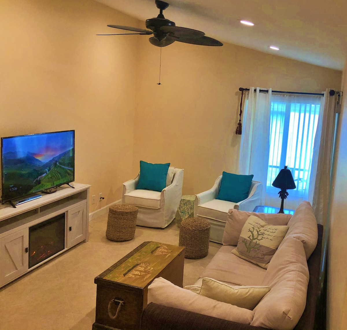 Living Room  with 50" smart TV and electric fireplace.