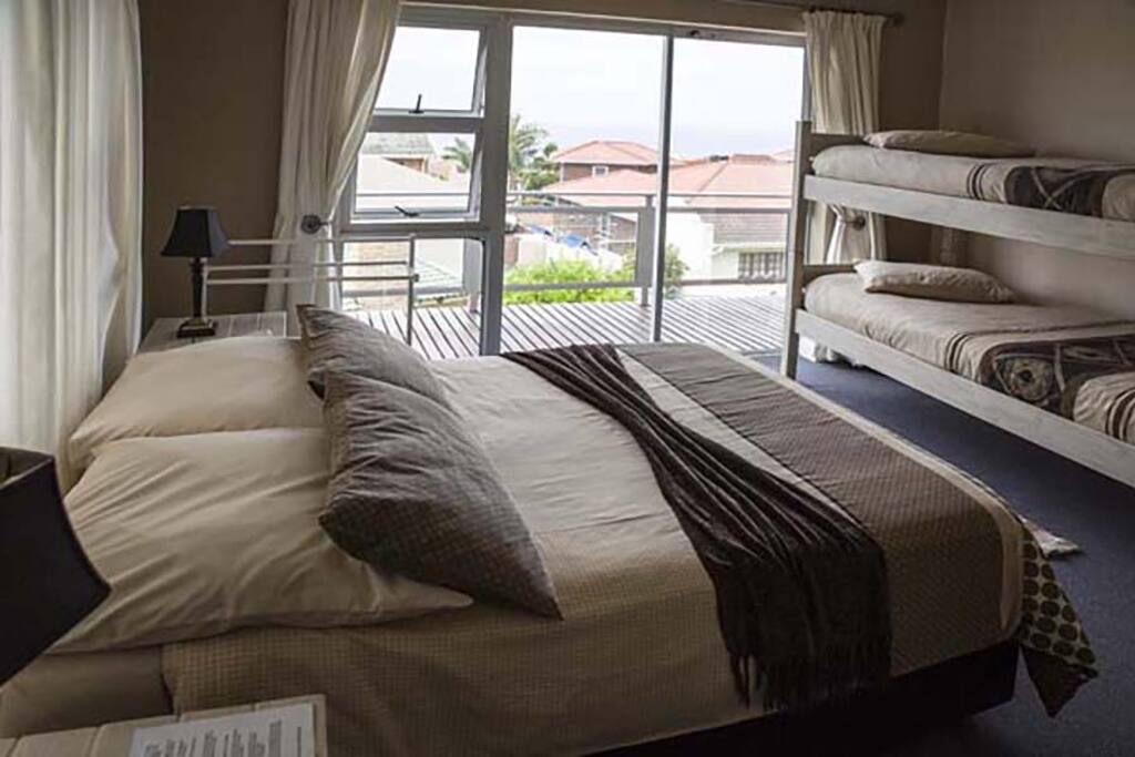 The second bedroom upstairs going out on balcony with view.