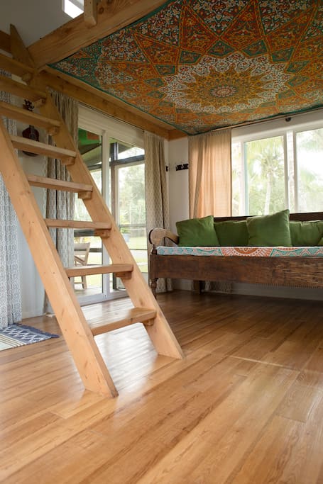 Ladder to sleeping loft with a king bed.