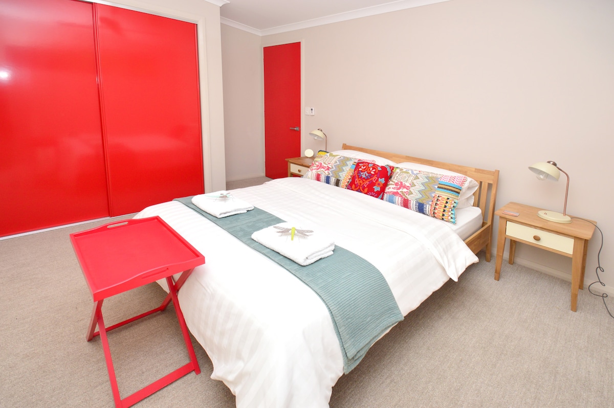 Spacious bedroom with queen size bed and valley views