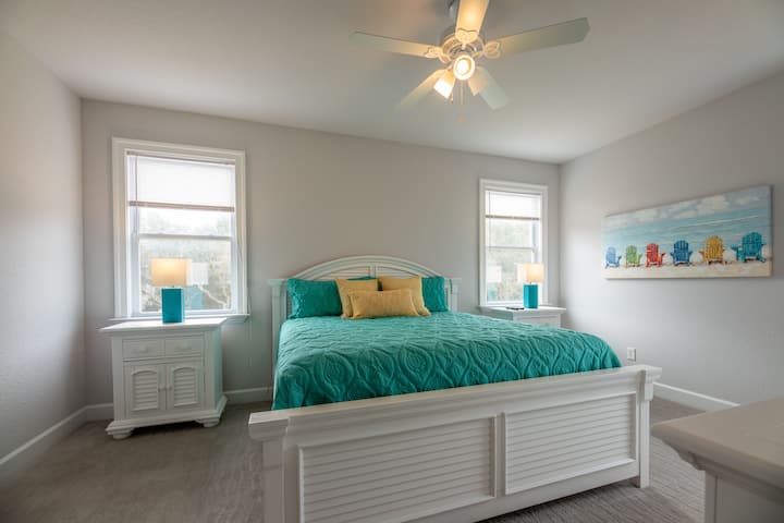 Up one flight of stairs brings you to to First level King bedroom suite with TV and ceiling fan - windows look out over backyard!