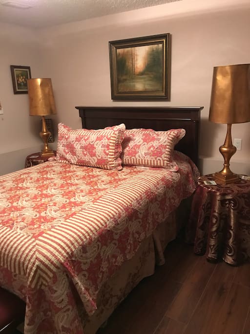 Bedroom E with a queen size bed in the basement