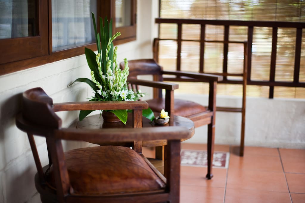 Terrace with coffee table and chairs facing to rice field view