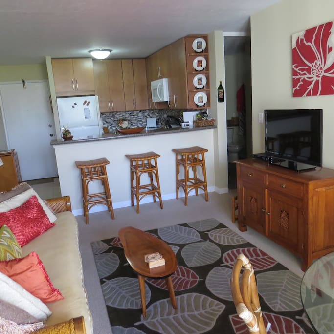 Spacious living room looks in to full kitchen